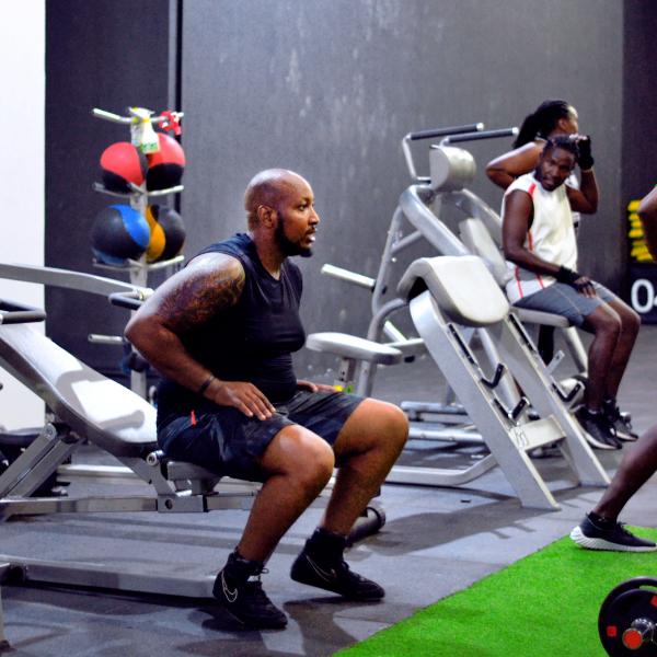 A member training on strength equipment at Zoezi Fitness Club