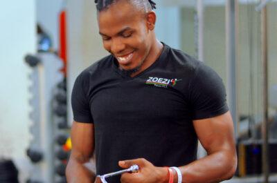 A Zoezi coach on the gym floor between equipment stations